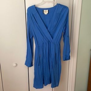 Blue faux wrap dress with zipper pocket accents